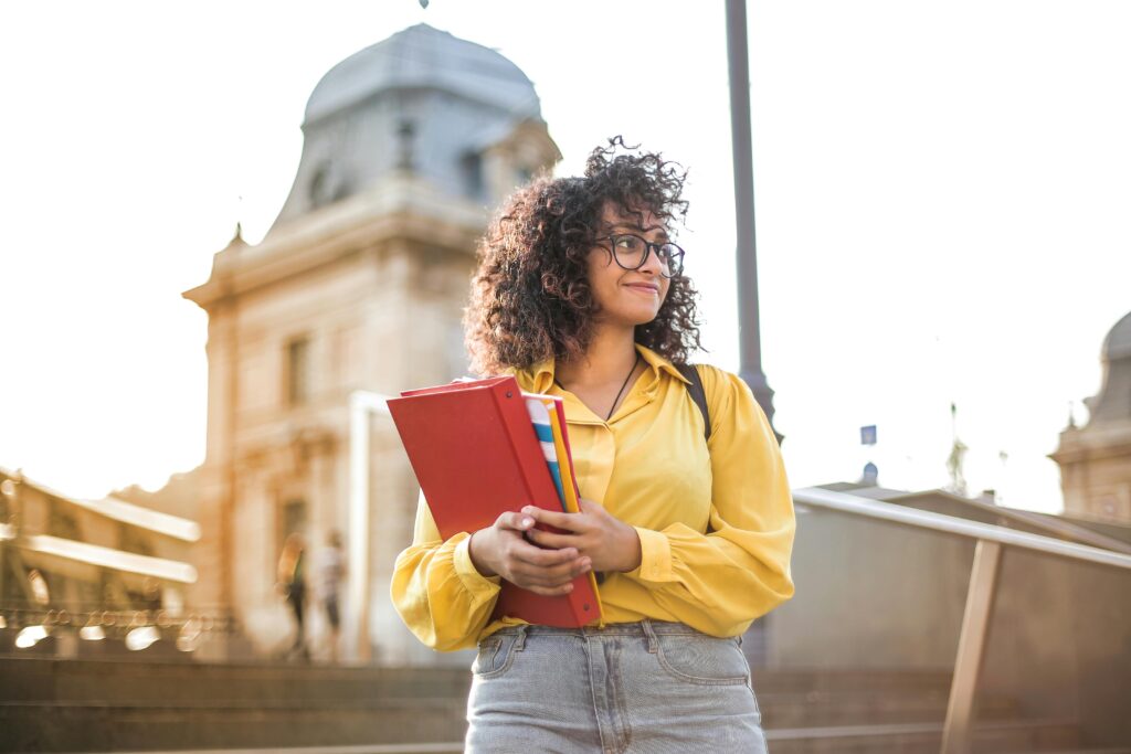 Confident girl holding books