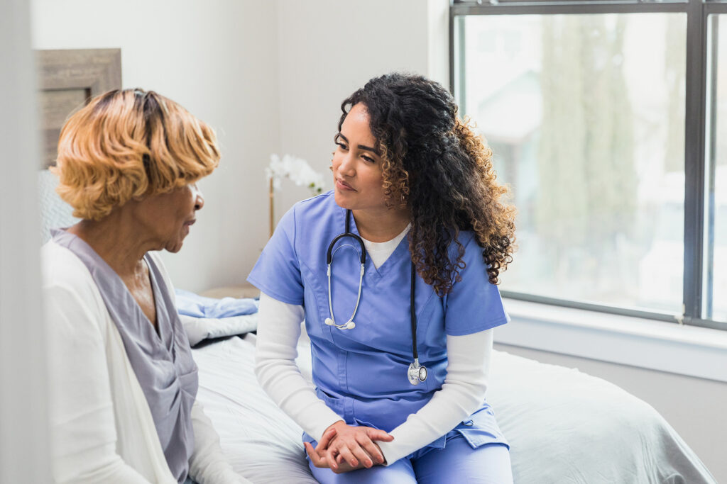 A nurse practioner meeting with a patient in a room
