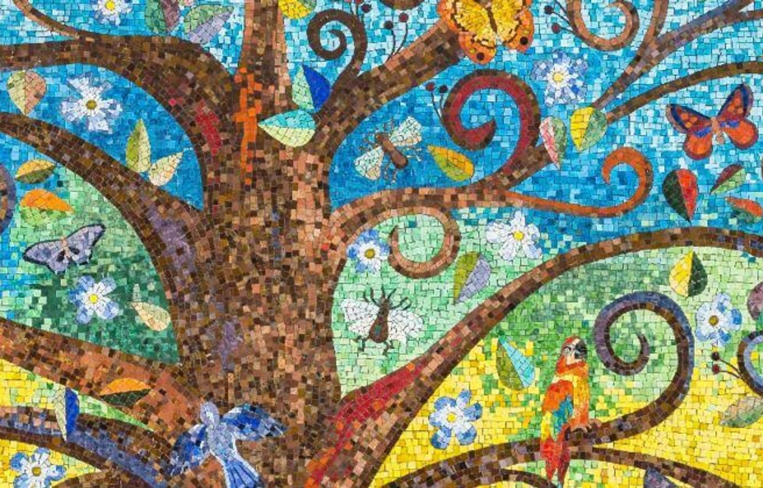 Colorful mosaic artwork depicting a large tree with twisting branches against a blue sky. The tree is surrounded by flowers, butterflies, birds, leaves, and insects in vibrant shades of blue, green, yellow, orange, and purple, creating a whimsical nature scene.